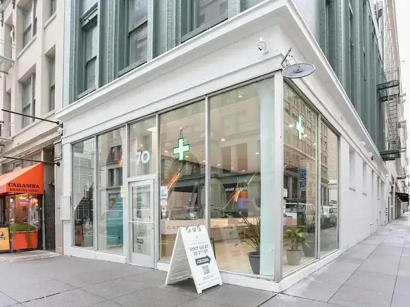 Cannavine dispensary exterior with glass windows and sidewalk sign in San Francisco