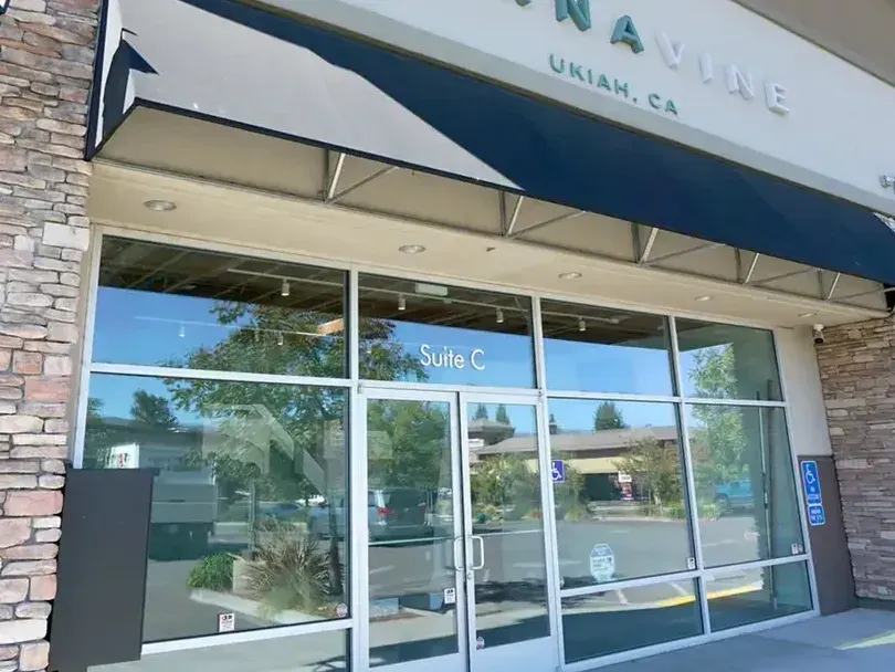 Cannavine Ukiah CA storefront with blue awning and stone pillars